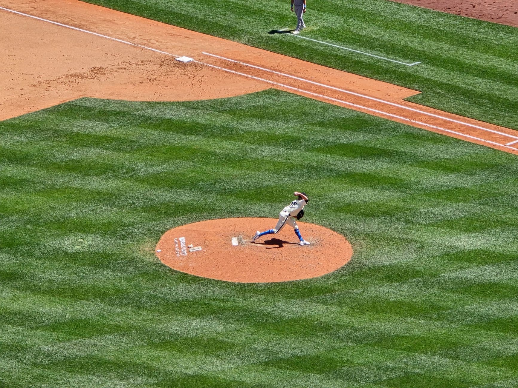 Dynamic shot of a baseball pitcher in action on a sunny day at Seattle stadium.